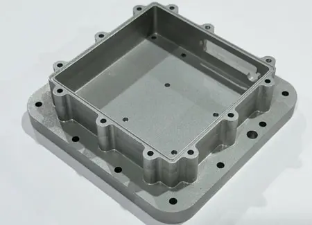 Precision 5-axis CNC machined aerospace component made from aluminum, showcasing complex structural pockets and tight-tolerance counterbored holes.